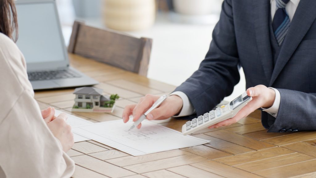 Hands of a businessman calculating a real estate estimate