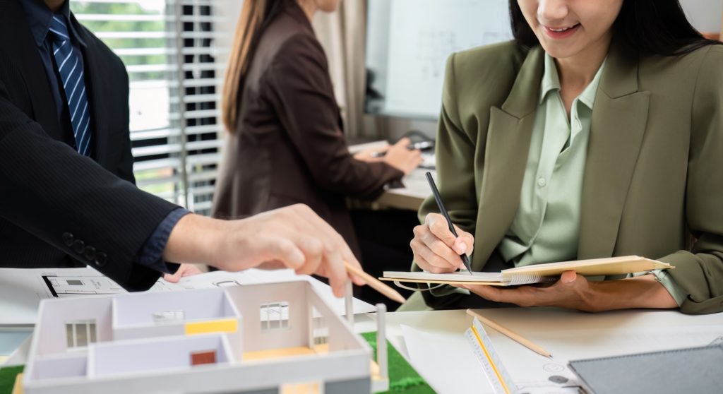 Real Estate Project Sales Team Planning Marketing Strategy in Modern Office Setting