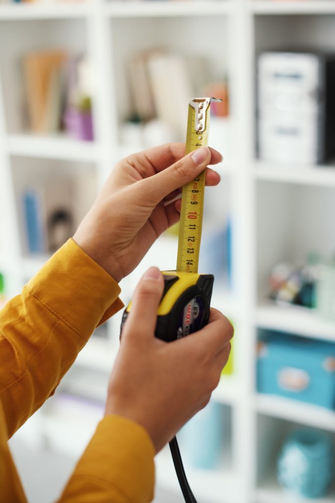 Woman holding a roll meter
